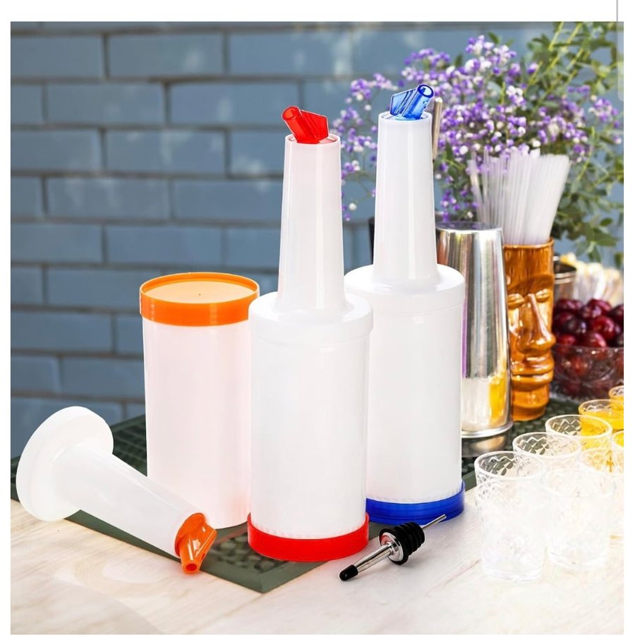 White practice pour bottles with red, blue and orange spouts and bases, beside a bar spoon pourer and cocktail glasses